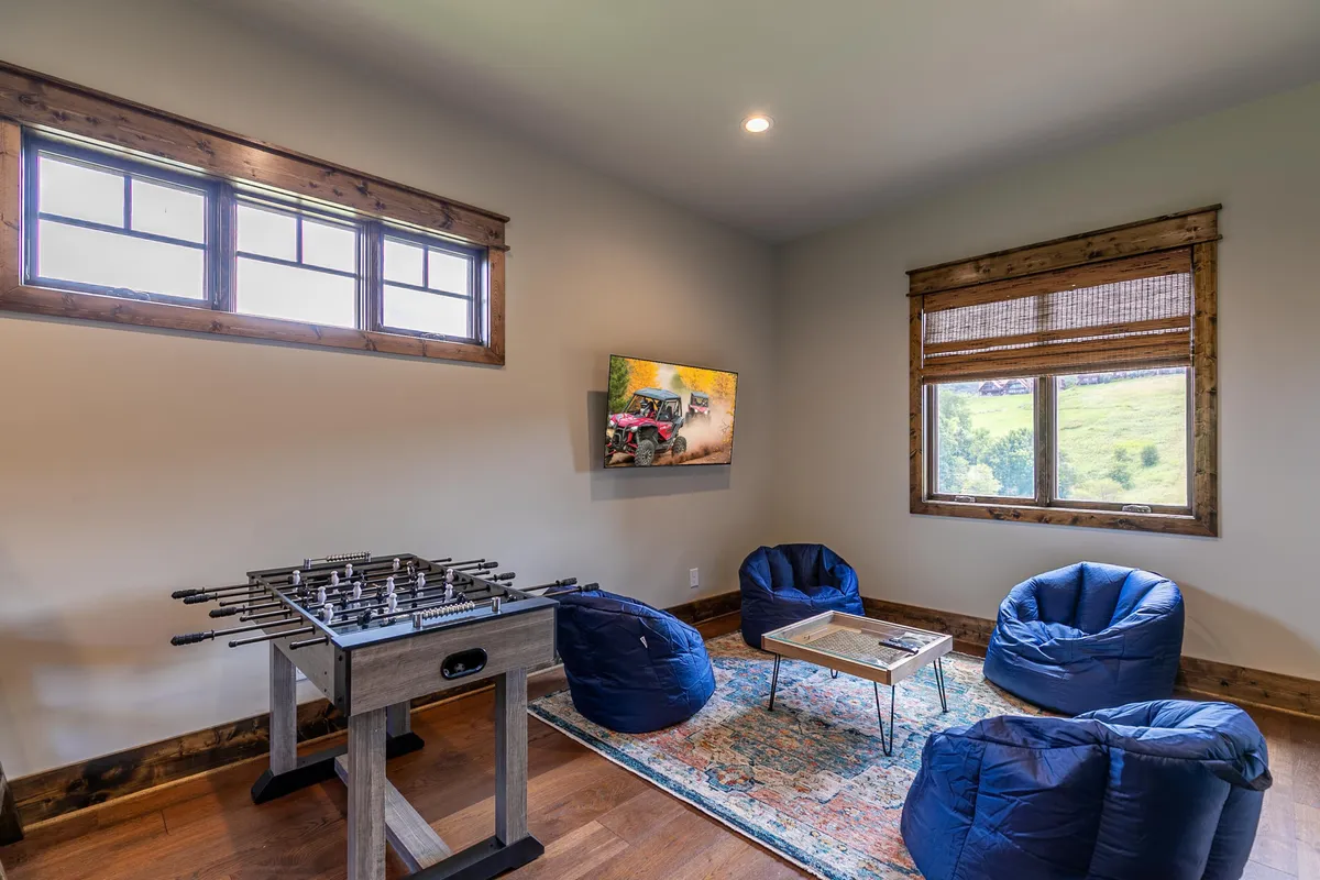 A playful entertainment zone with a foosball table and bean bag chairs, complemented by contemporary artwork on the wall. The space exudes a relaxed, fun atmosphere perfect for friendly competitions or casual hangouts.